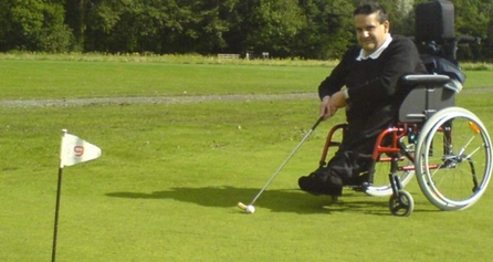 Person in wheelchair playing golf